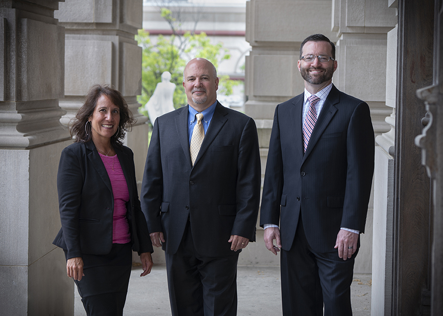 Stifel Pathway Advisory Group standing in front of courthouse.  Left to right: Patty Horner Senior Registered Client Service Associate, Michael Rose Vice President/Investments, Scott Gillespie Financial Advisor